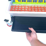 Hatching Time Cimuka 15" Grow out pen. Manure tray being pulled out of bottom of grow out pen. Feeding trough can be seen with smart feeder grill.
