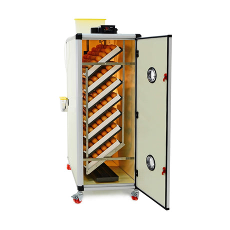 Hatching Time Cimuka. Image shows open HB Series incubator with door open showing 7 setting trays full of brown chicken eggs. Digital control can be seen on top of incubator and water reservoir tank connected to humisonic humidifer can also be seen in image.